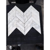 White calacatta verde royale marble 3x12 polished-honed tiles arranged in a chevron mosaic pattern