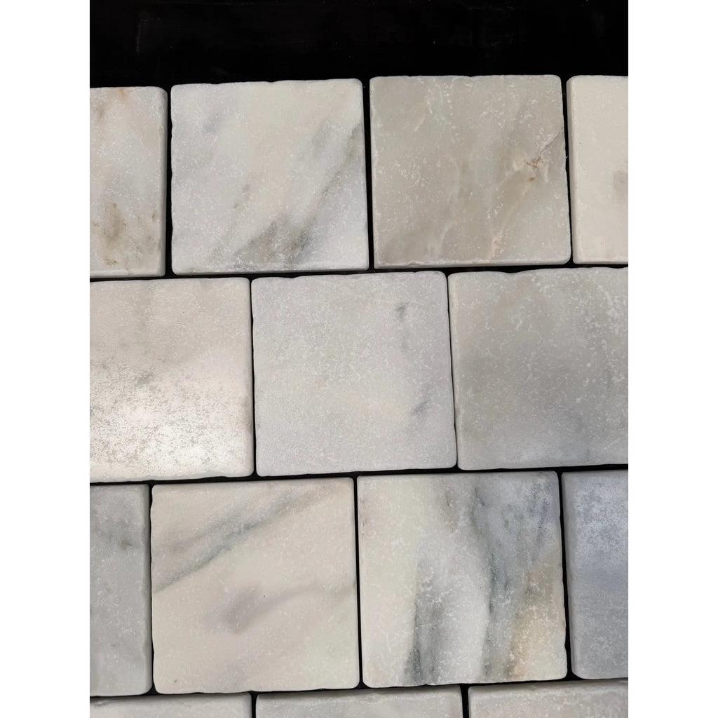 Square white Calacatta Verde Royale marble 4x4 tile with subtle gray veining arranged in a neat grid pattern