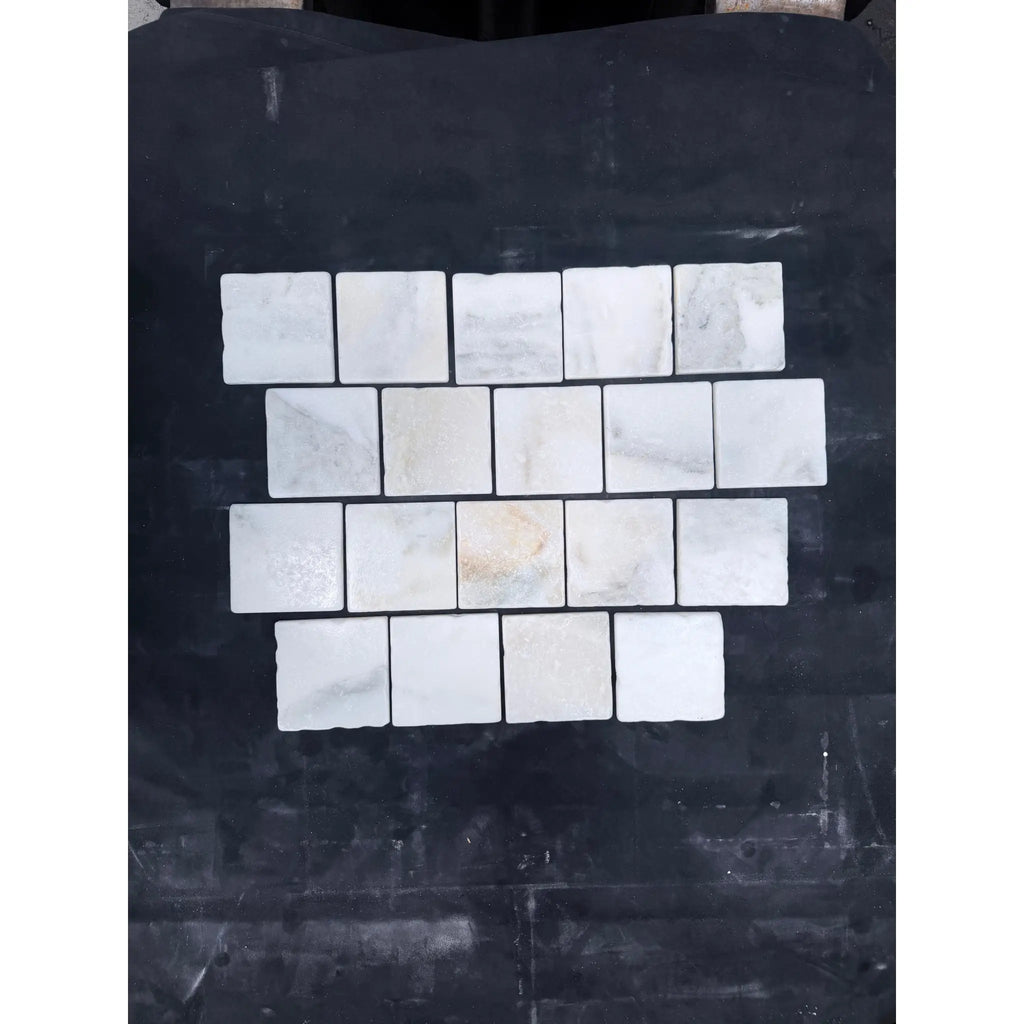 Calacatta verde royale marble 4x4 tile tumbled featuring white marble mosaic tiles with subtle gray veining in a grid pattern