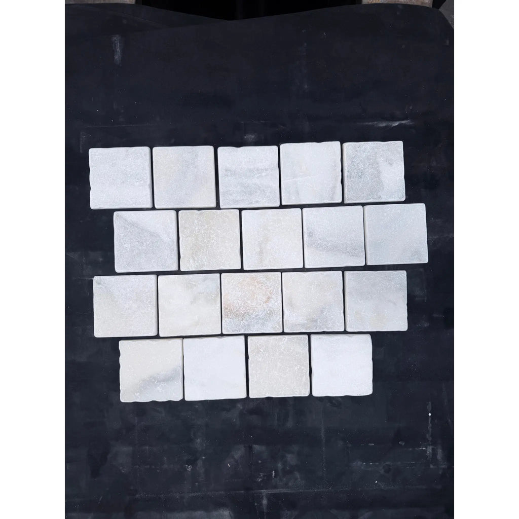 Calacatta verde royale marble 4x4 tile tumbled with white marble mosaic tiles and subtle gray veining in staggered pattern