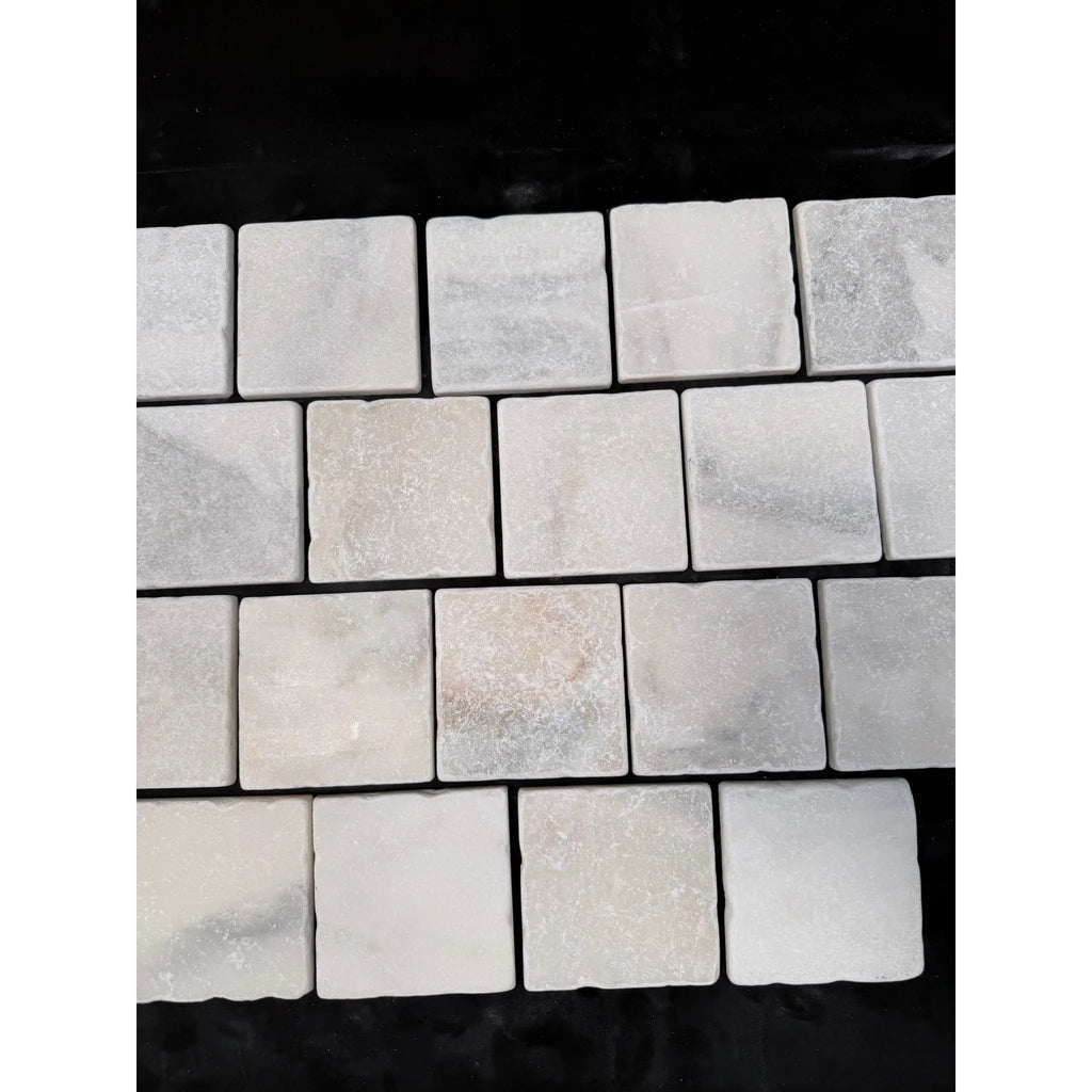 Calacatta verde royale marble 4x4 tile tumbled white marble mosaic with subtle gray veining in a neat grid pattern