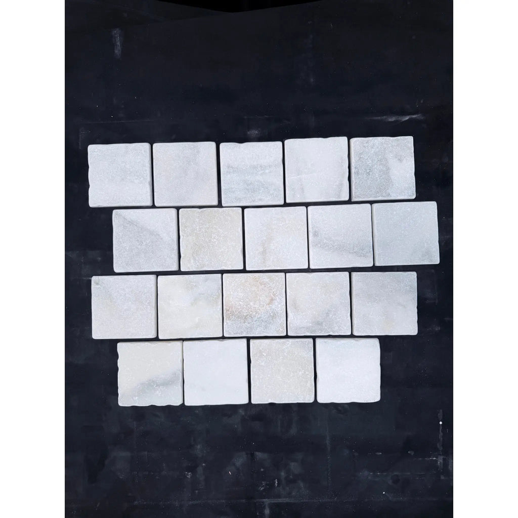 Calacatta verde royale marble 4x4 tumbled tile with white marble mosaic and subtle gray veining in a grid pattern