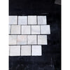 Calacatta verde royale marble 4x4 tumbled tile featuring white marble squares with subtle gray veining in staggered pattern