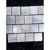 Calacatta verde royale marble 4x4 tile tumbled white marble with subtle gray veining arranged in a grid pattern