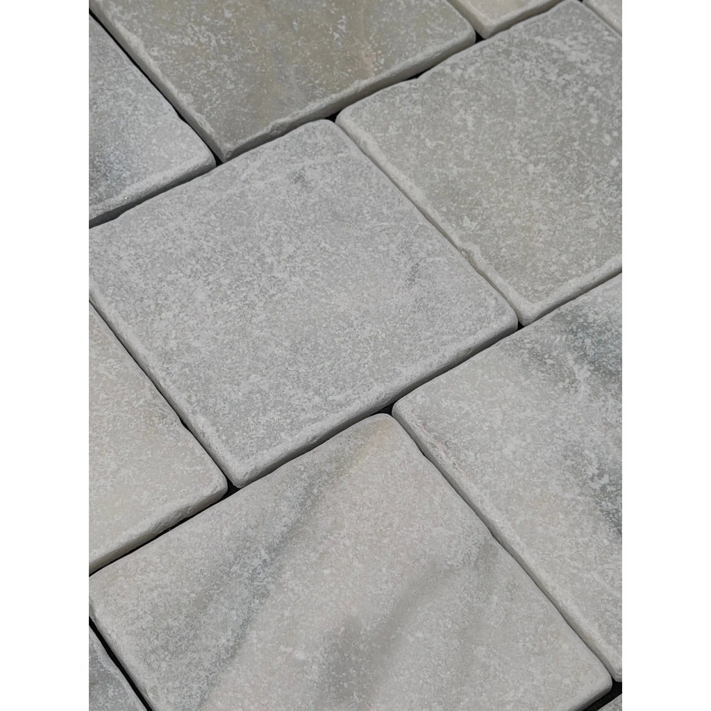 Calacatta verde royale marble 6x6 tile tumbled with gray stone pavers and a textured slightly uneven surface