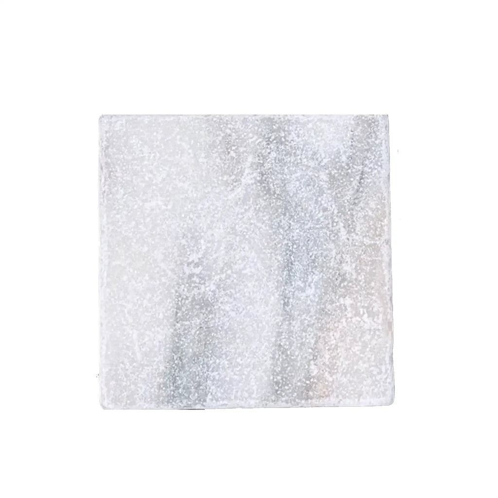A 6x6 translucent glass calacatta verde royale marble tile with frosted white and gray marbled pattern tumbled finish
