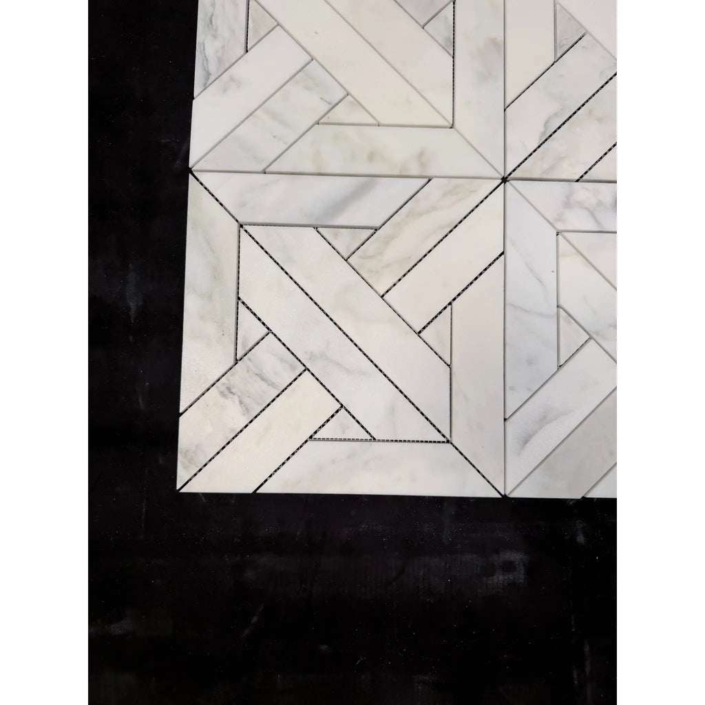 Calacatta verde royale marble heritage pattern mosaic tile in white marble with geometric herringbone design and dark grout lines
