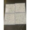 Four sheets of white penny round mosaic tiles wrapped in plastic for Calacatta Oliva Marble