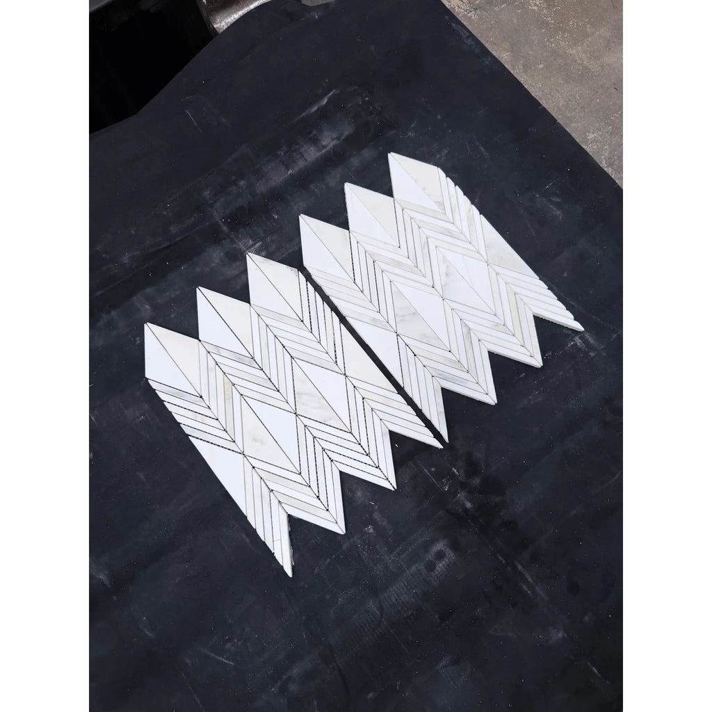 White marble mosaic tiles in a chevron pattern featuring calacatta verde royale marble polished-honed finish