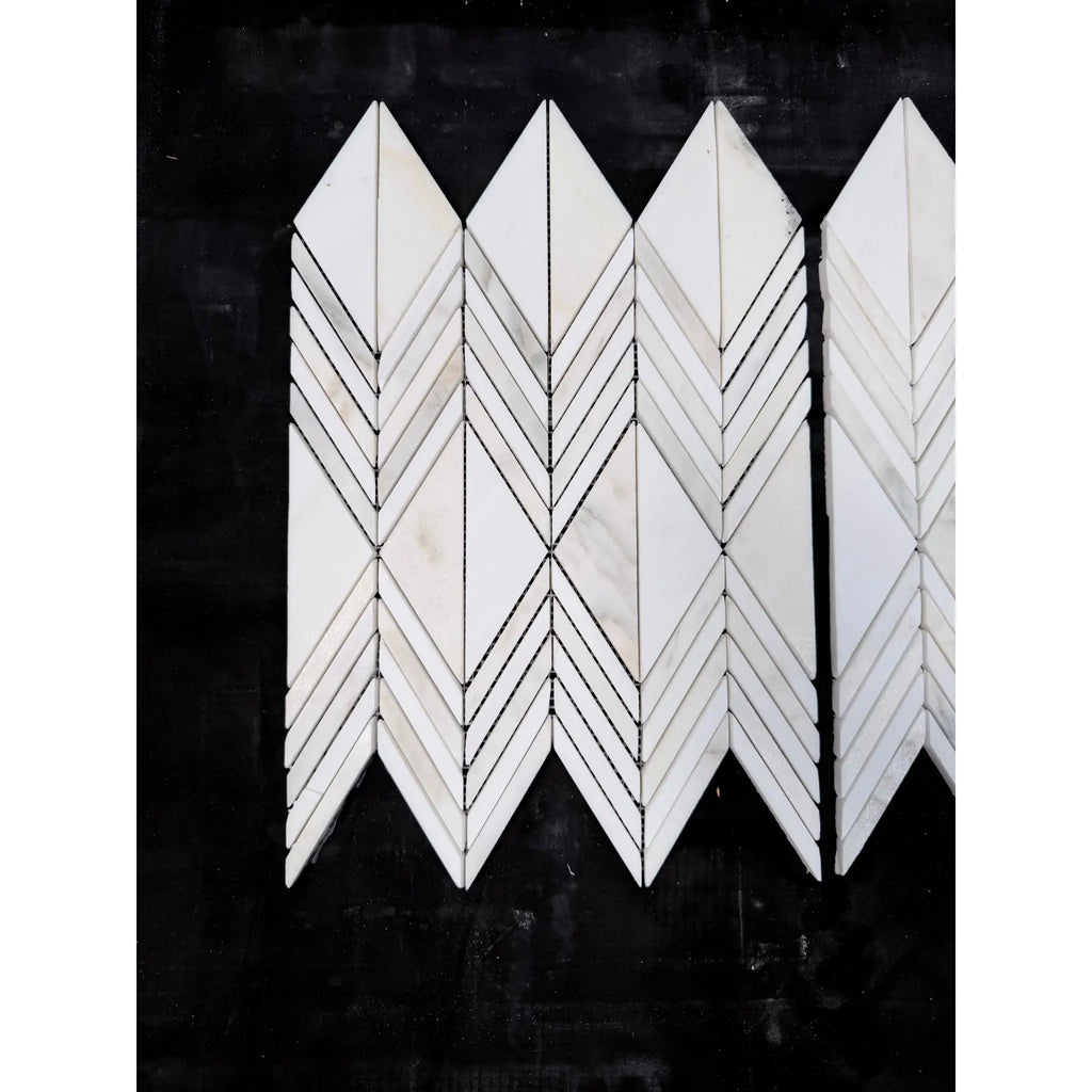White marble calacatta verde royale venezia mosaic tiles arranged in a polished-honed chevron geometric pattern