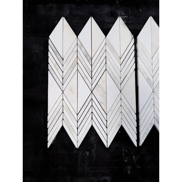 White marble calacatta verde royale venezia mosaic tiles arranged in a polished-honed chevron geometric pattern