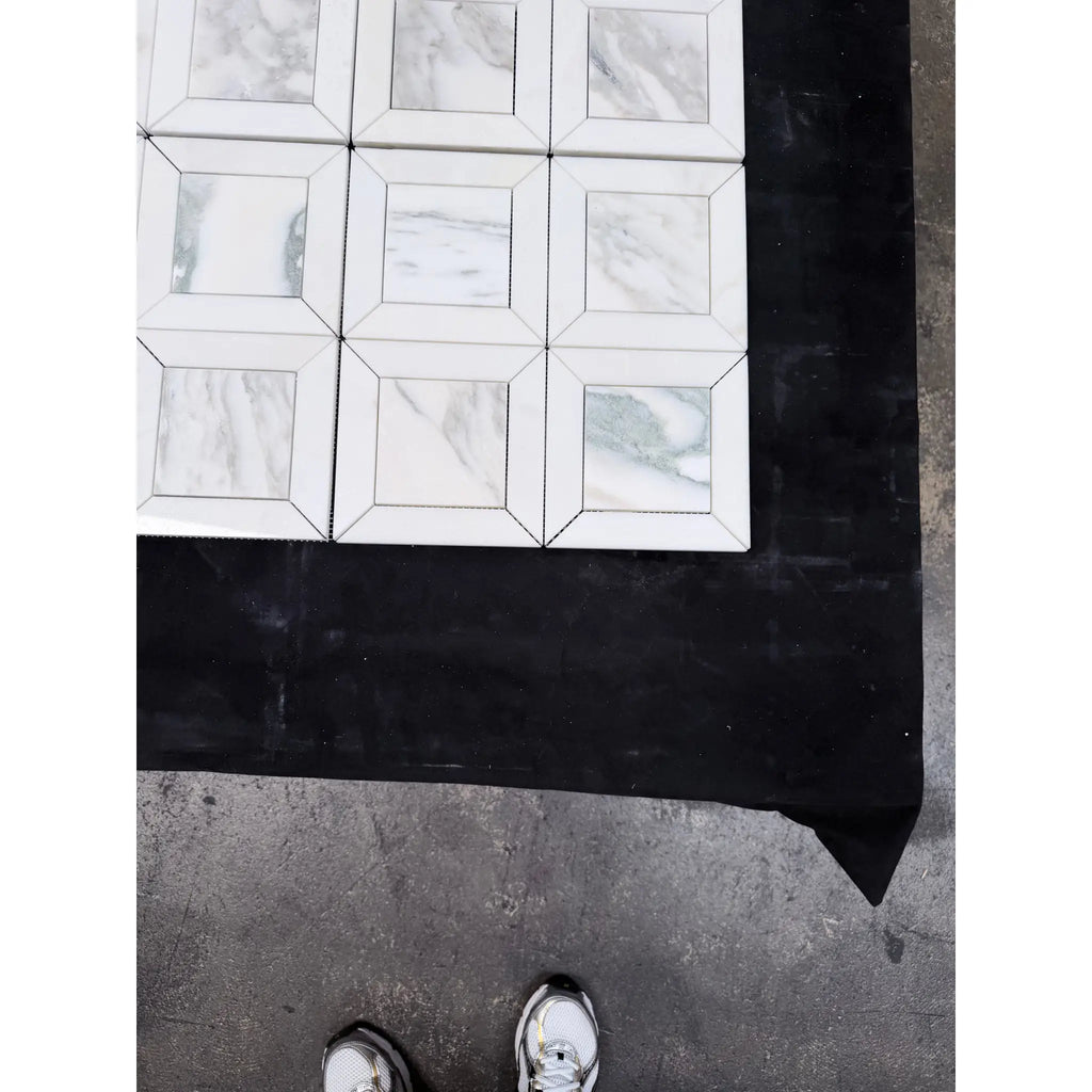 White marble-effect square tiles with subtle gray veining in a calacatta verde royale multi finish marble mosaic grid pattern