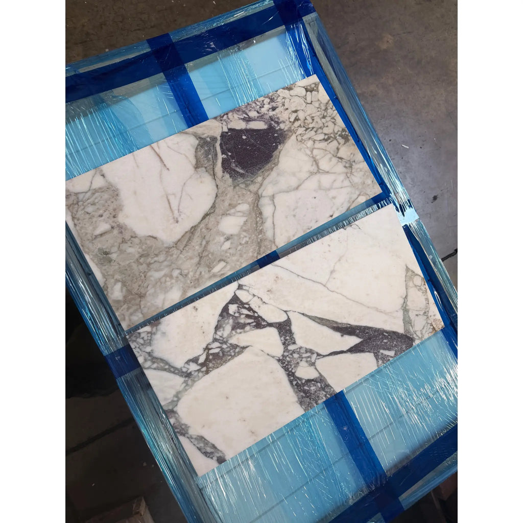 Calacatta Viola Imperiale marble 12x24 polished-honed tiles with veining, wrapped in blue film