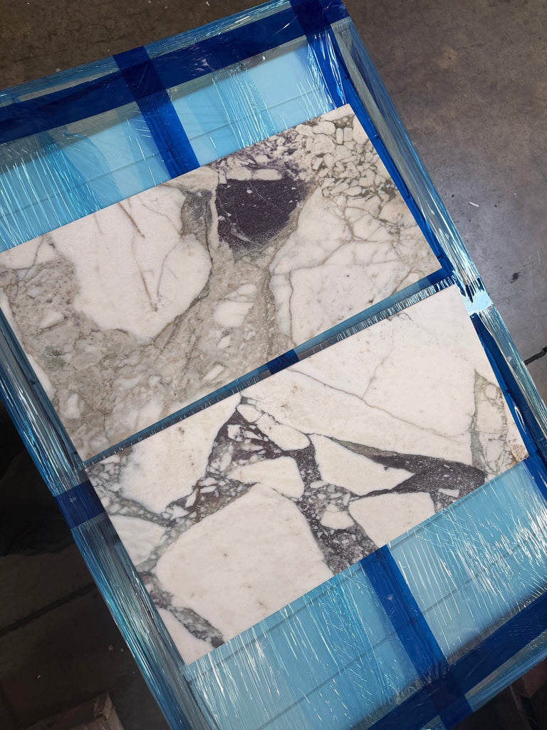 Calacatta Viola Imperiale marble 12x24 polished-honed tiles with veining, wrapped in blue film