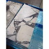 Calacatta Viola Imperiale marble slab, white with black gray veining, wrapped in plastic