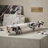 Calacatta viola imperiale marble 2x12 milano chairrail trim polished white marble with dark veining on concrete pedestal