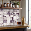 A sleek gold-toned hammered cocktail shaker with polished cap displayed on calacatta viola imperiale marble 2x2 mosaic