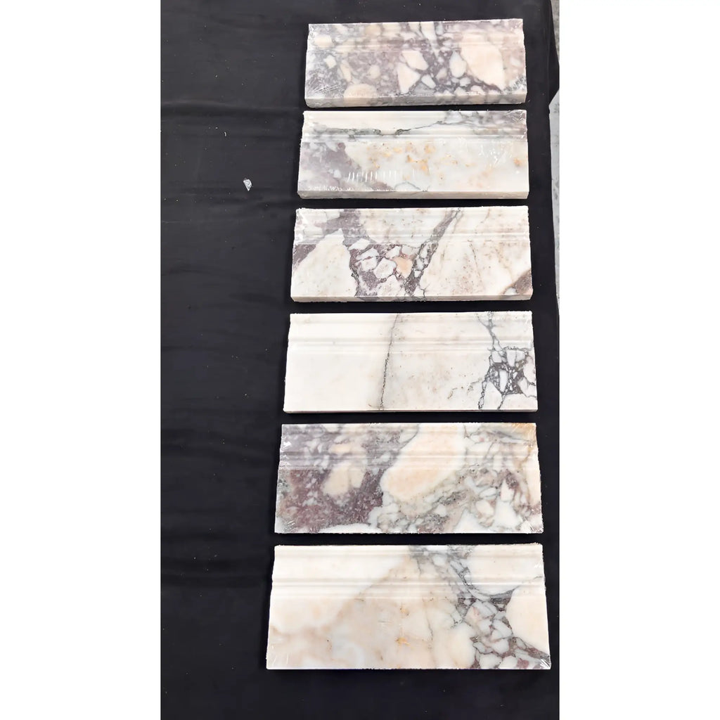 Calacatta Viola Imperiale marble baseboard trim in polished 4 3/4x12 tiles with white base and swirling gray, black, beige veining