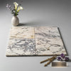 Four polished honed calacatta violetta royale marble tiles with white base and gray black golden veining 12x12 size