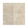 Four beige Cappuccino Marble 4X4 Tumbled tiles showcasing elegant natural design
