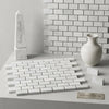 White indian marble obelisk with engraved text displayed alongside carrara white 1x2 brick mosaic marble tile polished or honed
