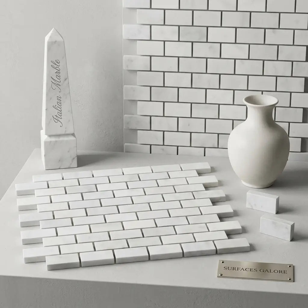 White indian marble obelisk with engraved text displayed alongside carrara white 1x2 brick mosaic marble tile polished or honed