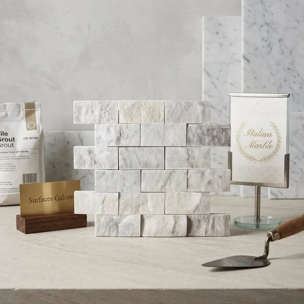 Stack of carrara white 2x4 brick mosaic marble tile split-faced with subtle gray veining arranged in staggered pattern