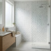 Carrara white 3-d small-bread mosaic marble tile polished with subtle veining covering shower wall