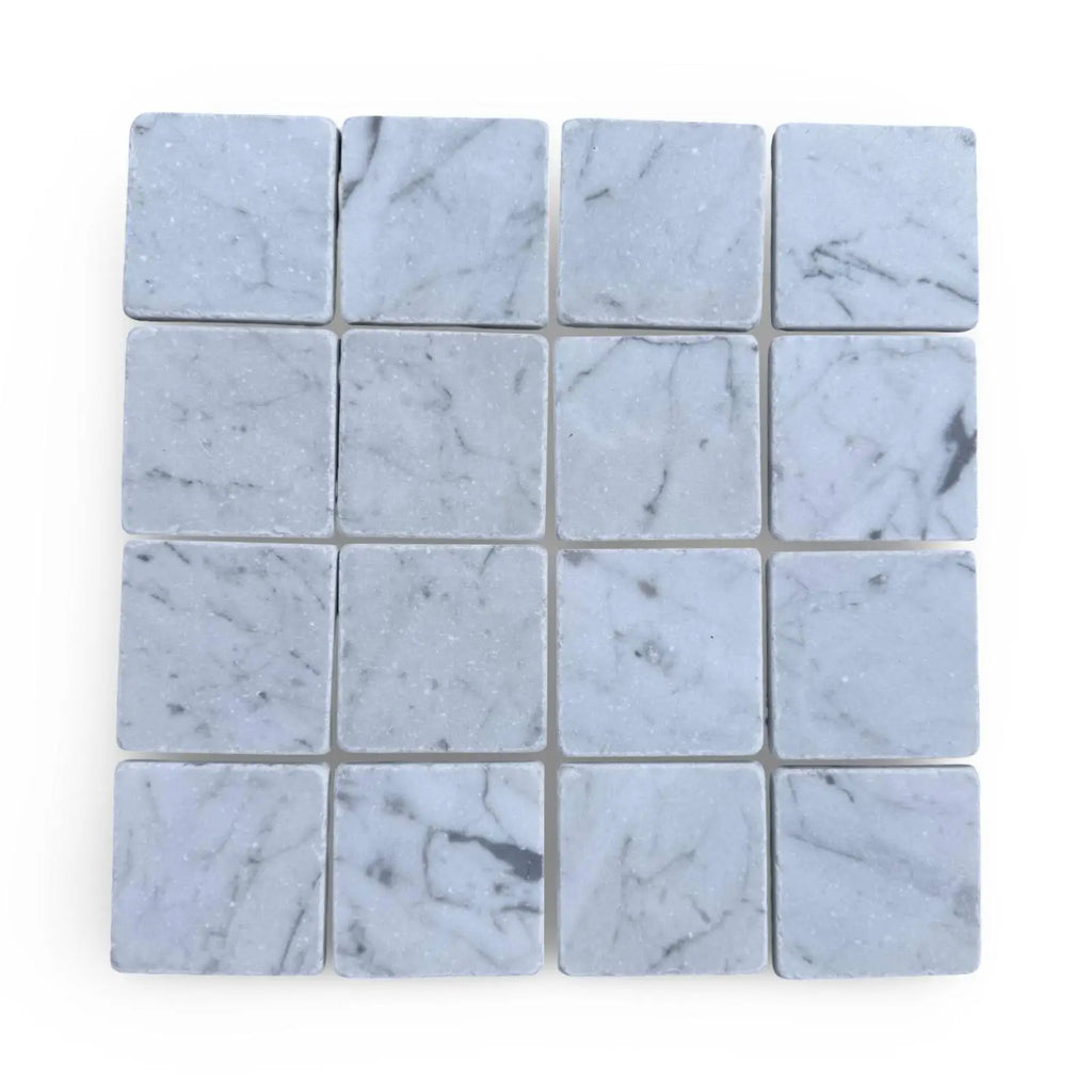 Light gray Carrara White 3x3 Tumbled marble tiles with subtle dark veining