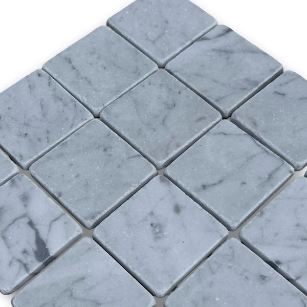 Light gray marble mosaic tiles in a diamond pattern for Carrara White 3x3 Tumbled flooring