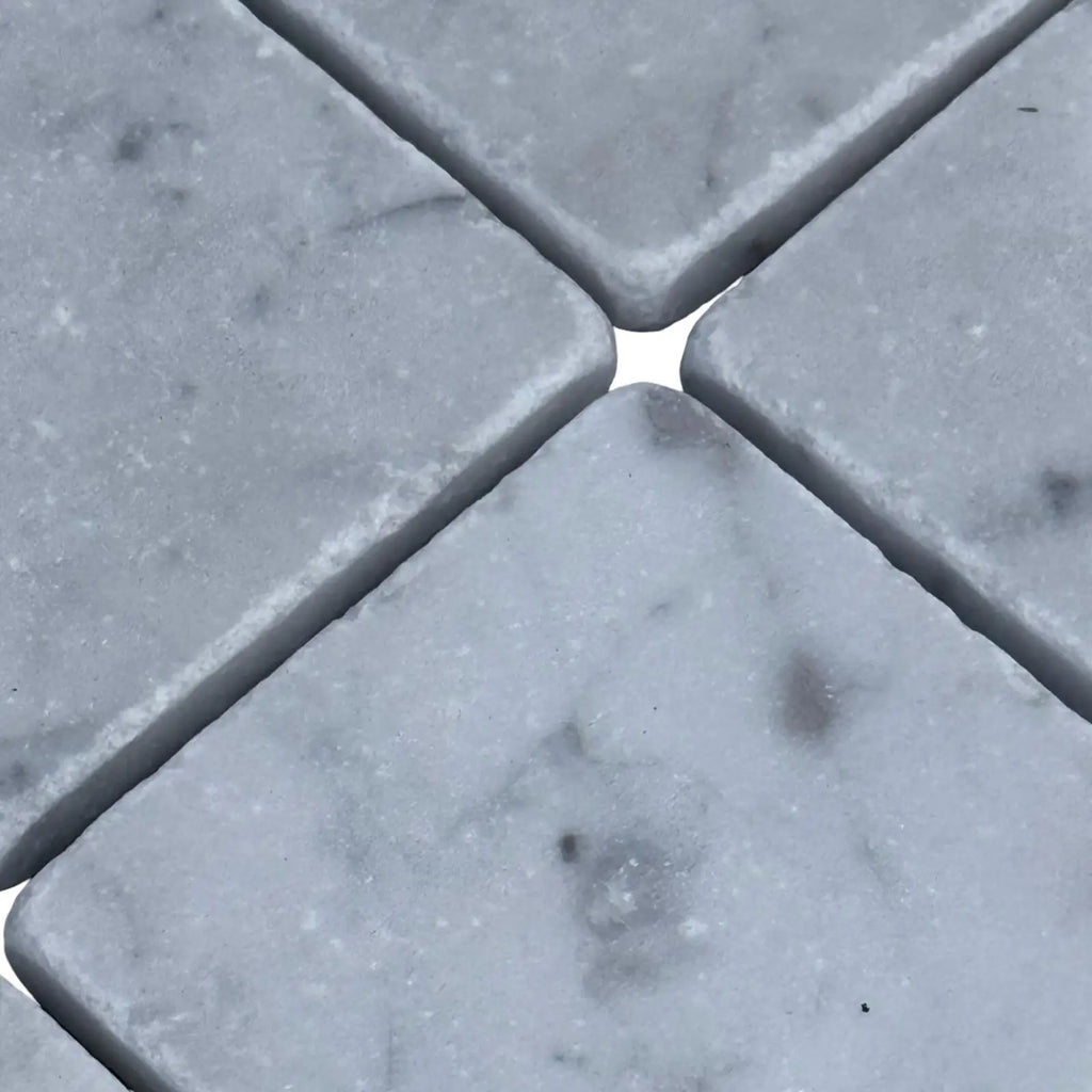 Light grey marble tiles with natural veining from Carrara White 3X3 Tumbled collection