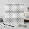 Carrara white mini-brick mosaic marble tile polished with subtle gray veining and black grout in 5/8 by 1 1/4 size