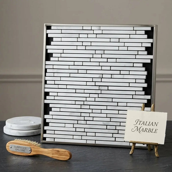 A sleek rectangular frame of carrara white bamboo sticks mosaic tiles in polished white marble with silver trim