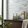 Gold faucet with sleek modern design and polished finish paired with carrara white bamboo sticks mosaic polished