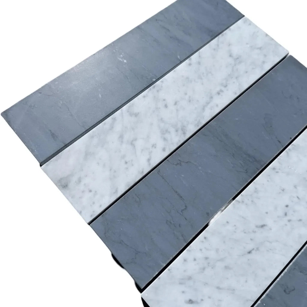 Alternating gray and white marble tiles of Carrara White Bardiglio Imperiale 3’’ X 12’’ Field Tile