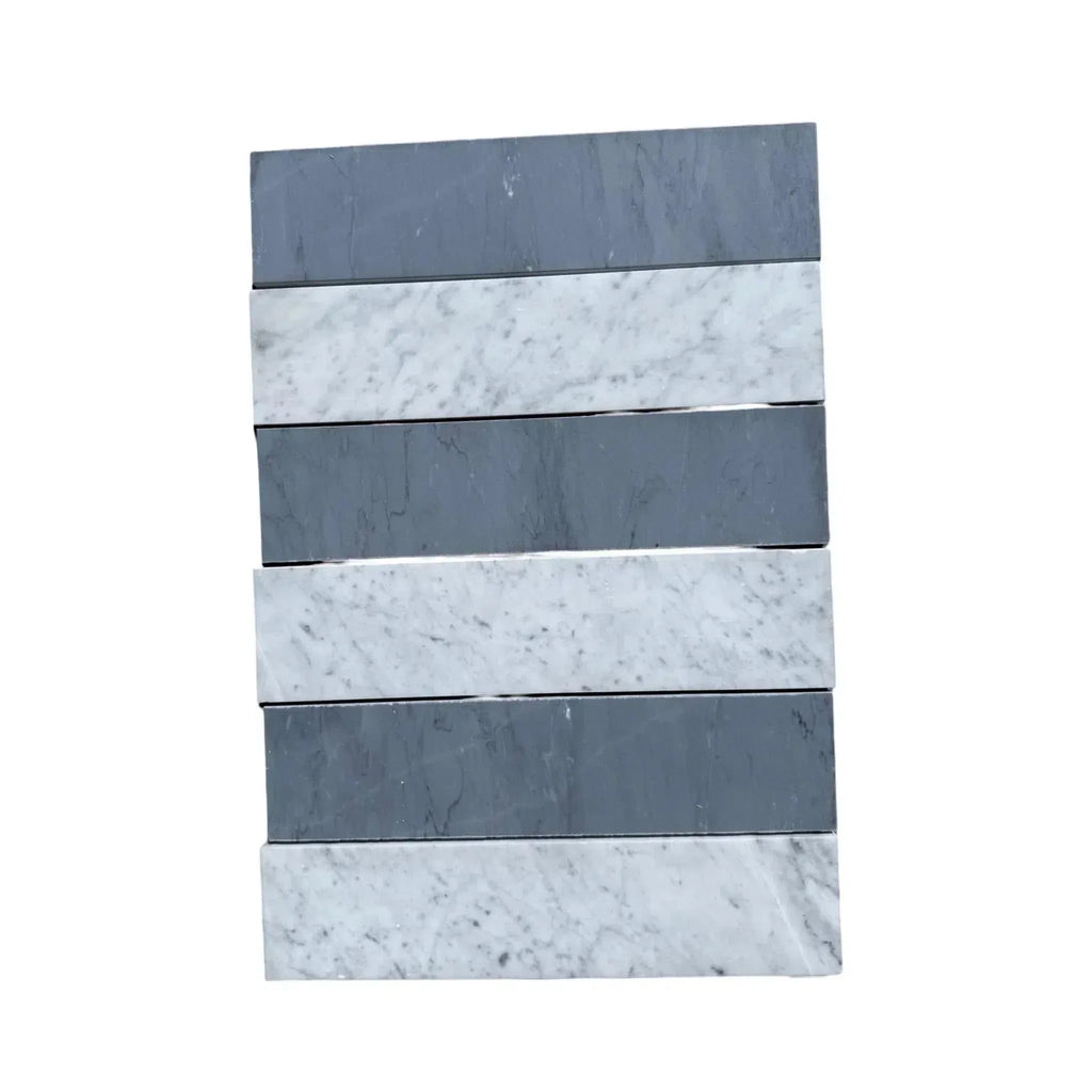 Stacked gray and white marble tiles of Carrara White Bardiglio Imperiale 3x12 field tile