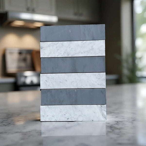 Stacked gray and white marble tiles of Carrara White Bardiglio Imperiale 3’’ X 12’’
