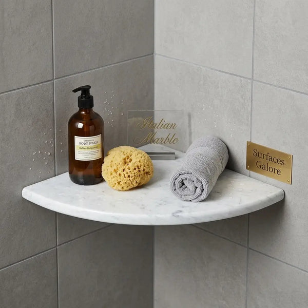 Carrara white marble shower corner shelf with a curved edge and subtle gray veining in Bianco Carrara Italian marble