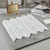 White italian marble mosaic tiles arranged in a polished herringbone pattern carrara white chevron mini tile