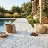 Two woven natural straw tote bags beside carrara white flat pebble paledian random broken mosaic marble tile pathways by pool