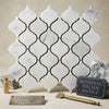 Carrara white lantern 3 inch polished marble tile with quatrefoil pattern and black grout lines in mosaic style