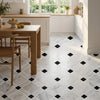 White marble mosaic tile with black diamond accents forming a geometric pattern for kitchen flooring