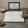 Carrara white marble 12x12 tumbled tiles with subtle gray veining arranged in a square pattern