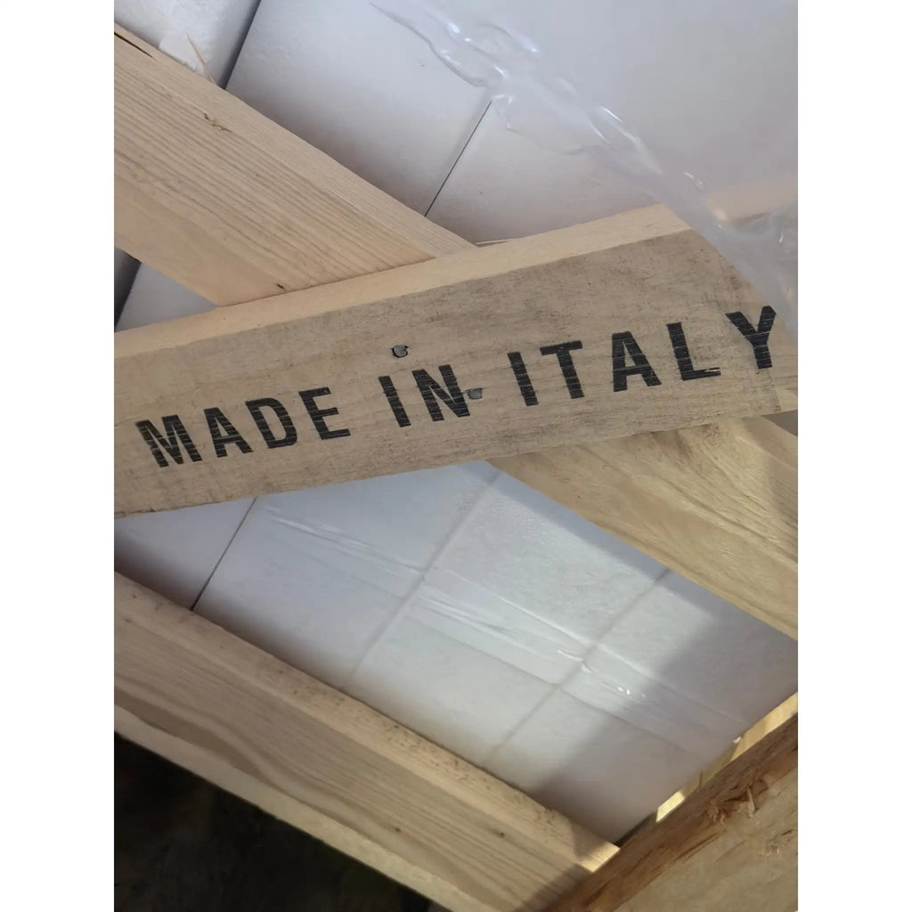 Light-colored wooden crate stamped made in Italy featuring Carrara white marble 12x24 polished or honed tiles