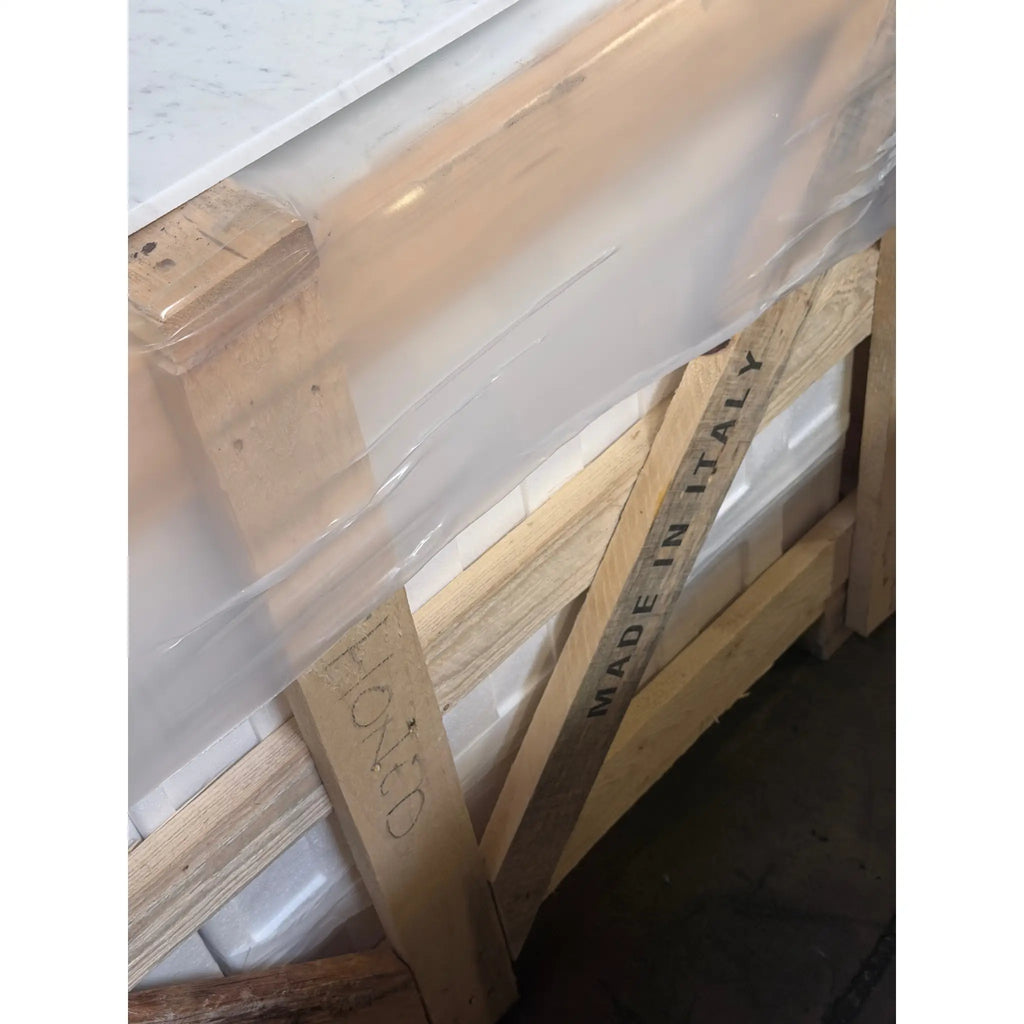 Wooden pallet with made in italy and elongo stenciled holding carrara white marble 12x24 polished or honed tiles wrapped partially