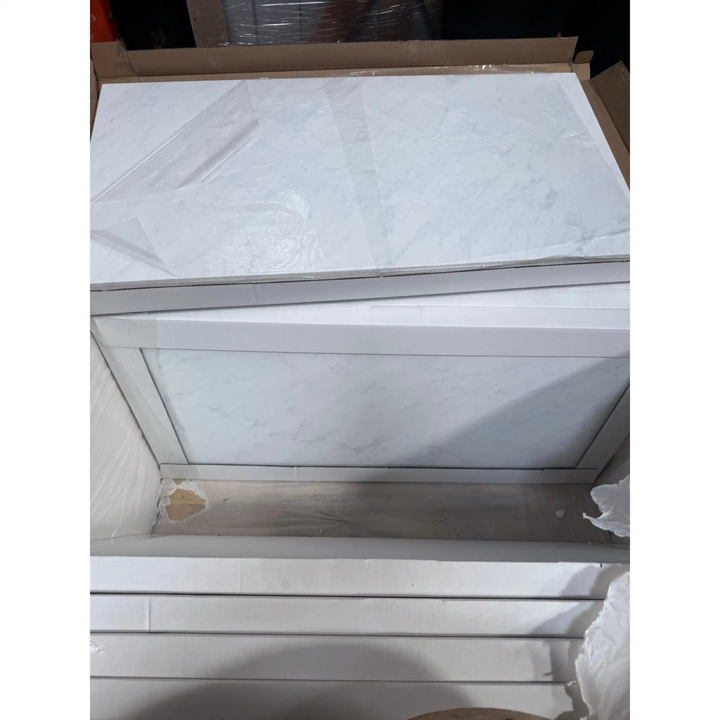 Stacked white marble panels from Carrara White Marble 18X36 collection