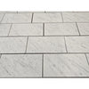 Carrara white marble 18x36 polished or honed tiles with subtle gray veining arranged in a staggered pattern