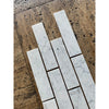 Carrara white marble 2x8 polished subway tiles with subtle gray veining in a classic white marble finish