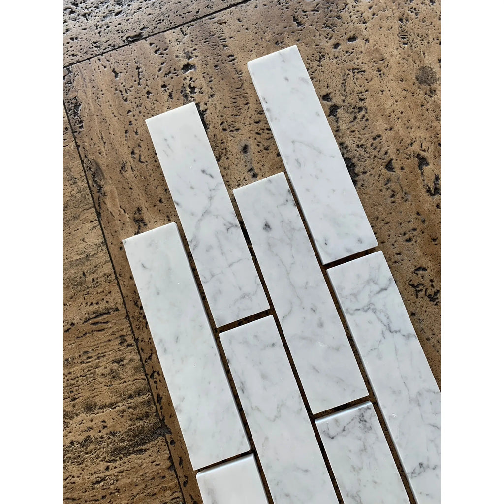 Carrara white marble 2x8 polished subway tiles with subtle gray veining in a classic white marble finish