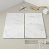 Four square carrara white marble 4x4 polished or honed tiles with subtle gray veining arranged in a grid